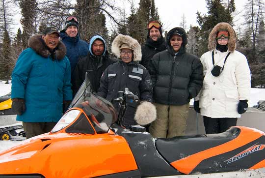 team around a snow mobile