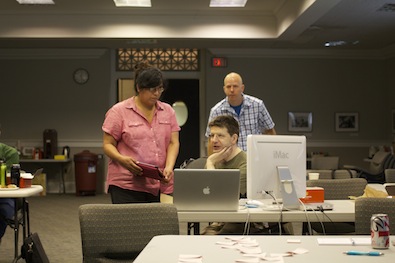 Heidi McCann listens to Simon Spero share his results of 'Uggi' with the group at the OPF Hackathon in Chapel Hill, NC. Photo Credit: Bram Van Der Werf.