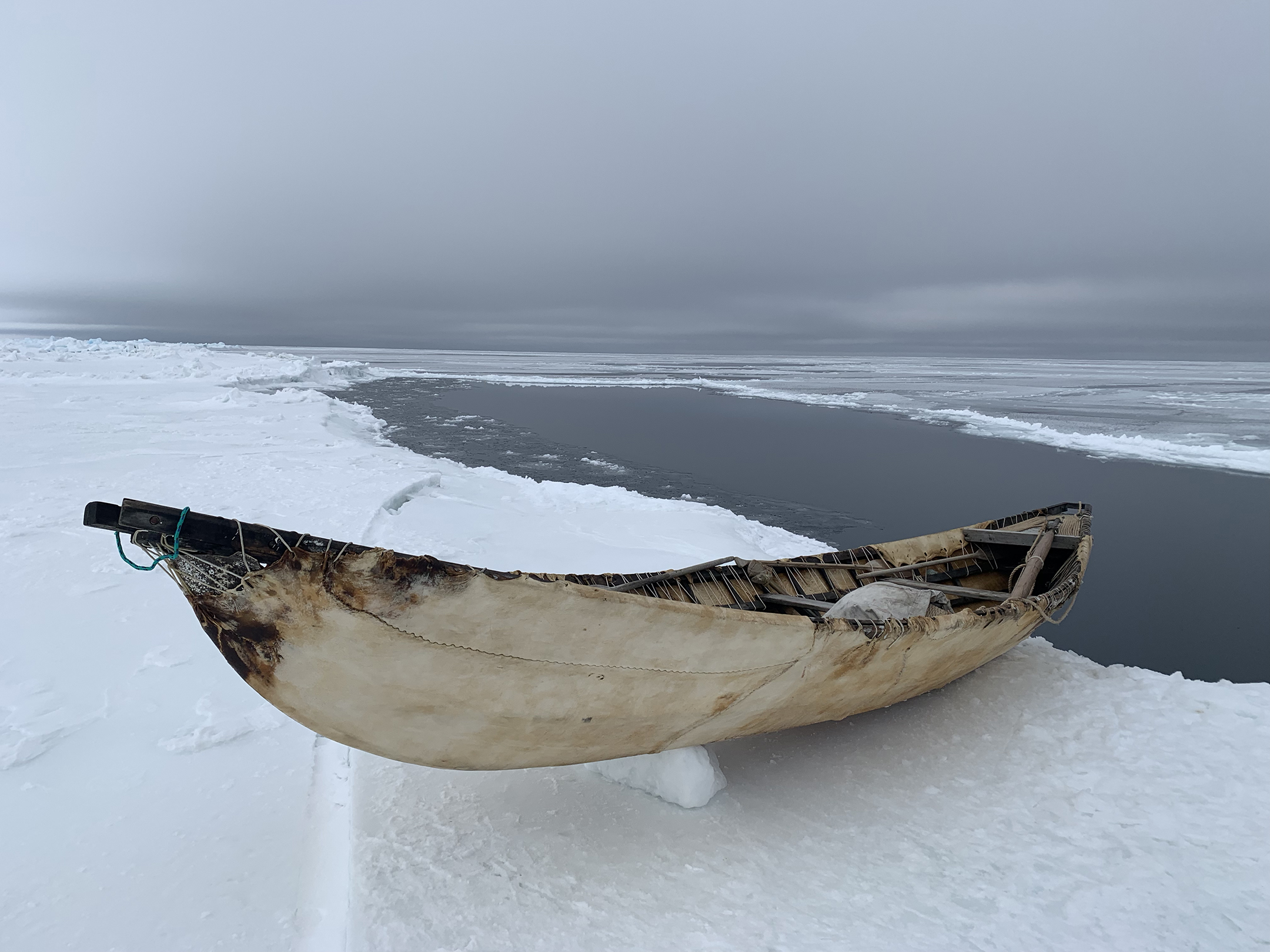 A traditional whaling boat rest on shorefast ice near the coast of Alaska.