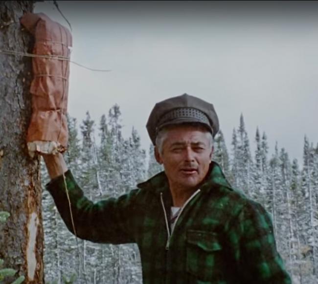 Sam Blacksmith tying birchbark bundle containing bears’s forelegs to tree (21:22) From the film&lt;br /&gt; “The Cree Hunters of Mistassini” (1974). Used with Permission of The National Film Board of Canada