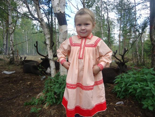 Mansi girl with domestic reindeer. Photo by Nadezhda Alekseeva, used with permission.